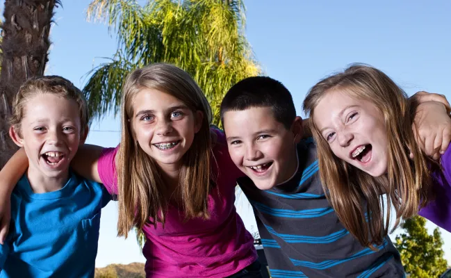 group of 4 kids smiling photo